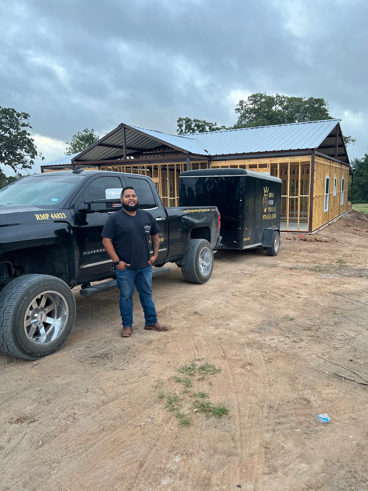 A man standing next to a black truck