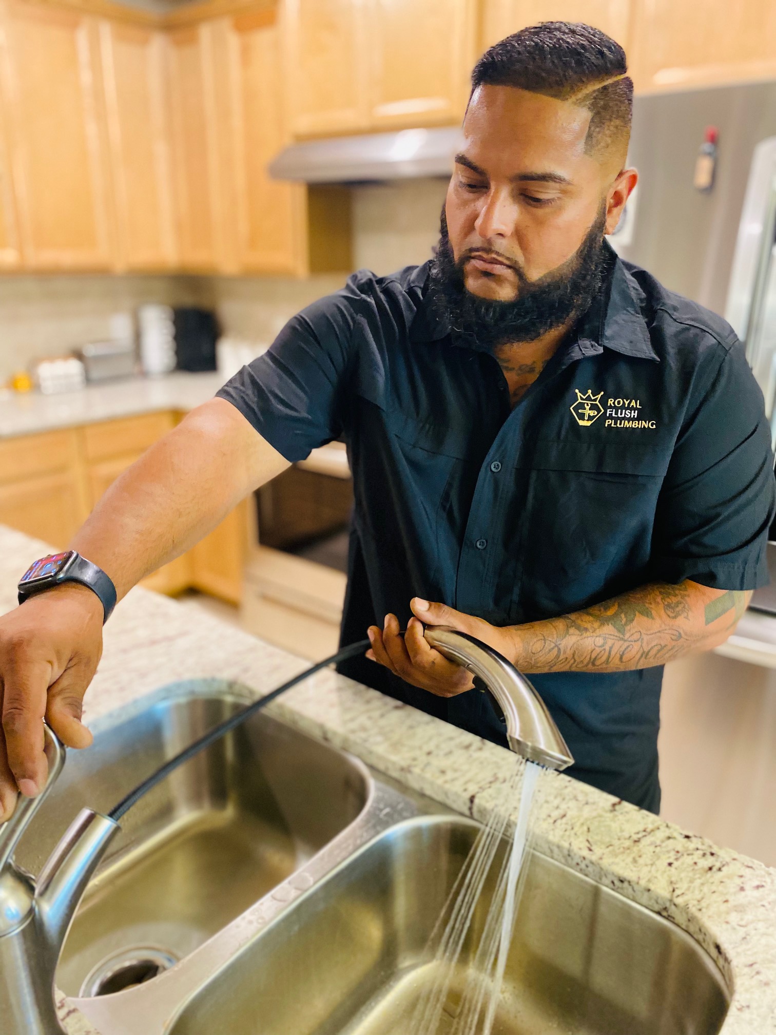 A man washing his hands in a kitchen sink